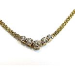 A gold flat-link necklace with five graduated diamonds in "V", stamped 14k.