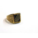 An 18ct gold signet ring, rectangular black onyx with four gold band detail, size V/W, 7.