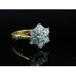 An 18ct gold diamond daisy ring, 1ct total diamond approx., size N, 4.