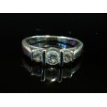 A white gold three stone diamond ring stamped 18k, size K, 3.