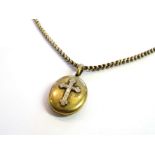 A Victorian oval locket surmounted by a cross, hung on gold watch chain, 32.