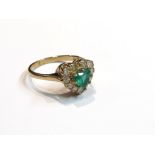 A 9ct gold emerald and diamond ring the central heart shaped emerald framed by brilliant cut