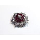 A diamond and ruby floral encrusted brooch the centre diamond .25ct approx.