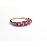 A 9ct gold pink sapphire six stone ring, size P, 1.