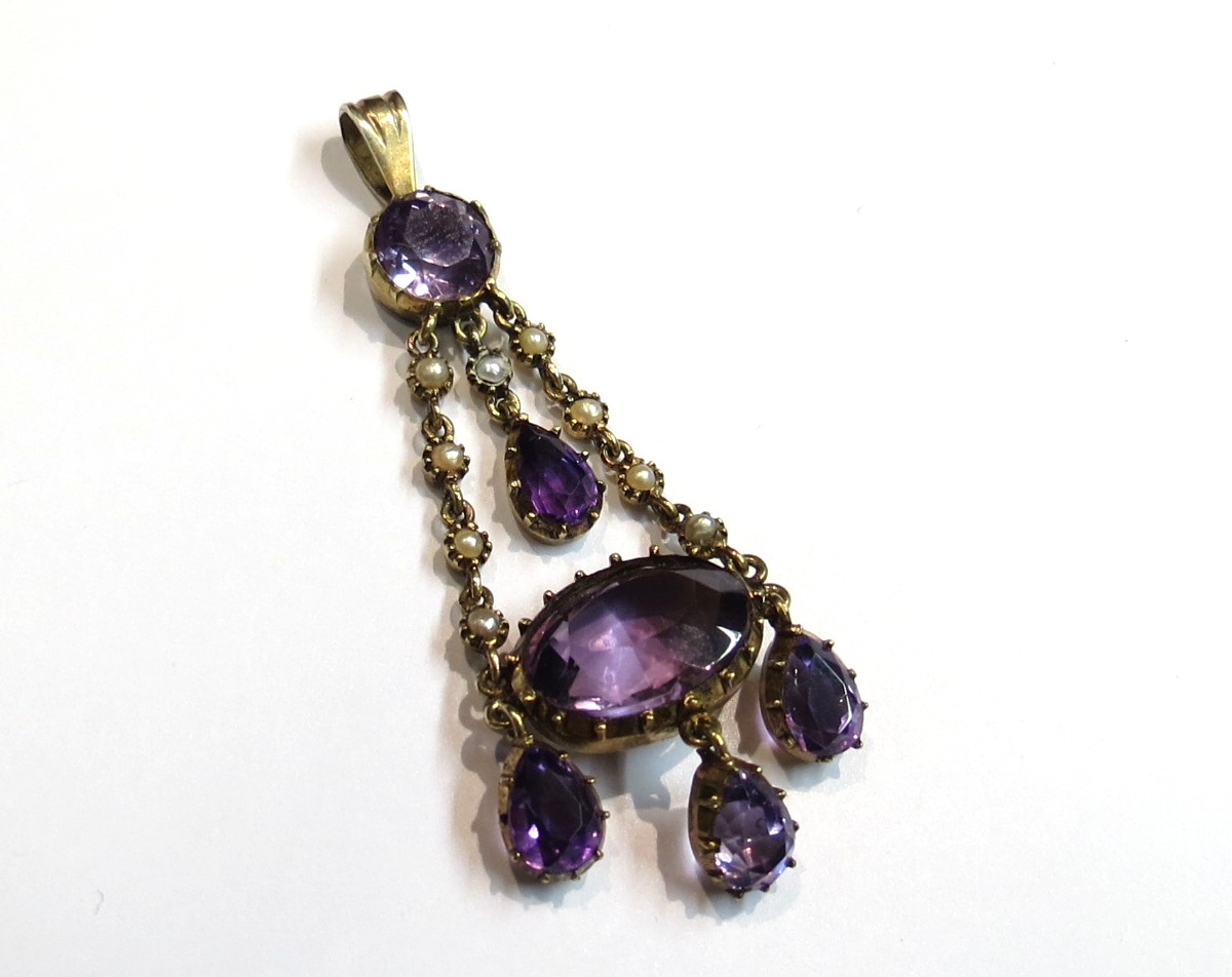 A Victorian amethyst and seed pearl pendant with four amethyst drops and large amethyst stone, 5.