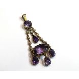 A Victorian amethyst and seed pearl pendant with four amethyst drops and large amethyst stone, 5.