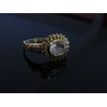 A 9ct gold ring the oval clear stone in fancy mount with sapphire set shoulders, size R, 3.