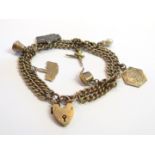 A 9ct gold bracelet hung with various charms including ballerina pearl and thimble,