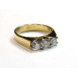 A three stone diamond ring stamped 750, size P, 5.