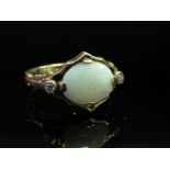 A 9ct gold opal and diamond ring, the central opal flanked by small diamonds, size K, 3.