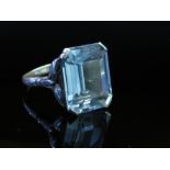 A white metal ring set with large emerald cut pale blue stone, size S, 5.