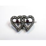 A brooch as entwined hearts set with old mine cut diamonds and rubies, 2.5cm length, 3.