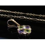 A gold suffragette pendant set with amethysts,
