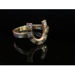 An 18ct gold "horseshoe" ring set with seven brilliant cut diamonds, size V, 5.