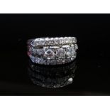 A white gold ring, the three bands each set with diamonds of varying size, stamped 18k Plat, size M,