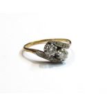 An 18ct gold platinum set diamond crossover ring, size N, 2.