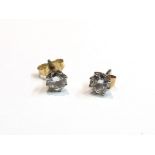 A pair of diamond stud earrings .