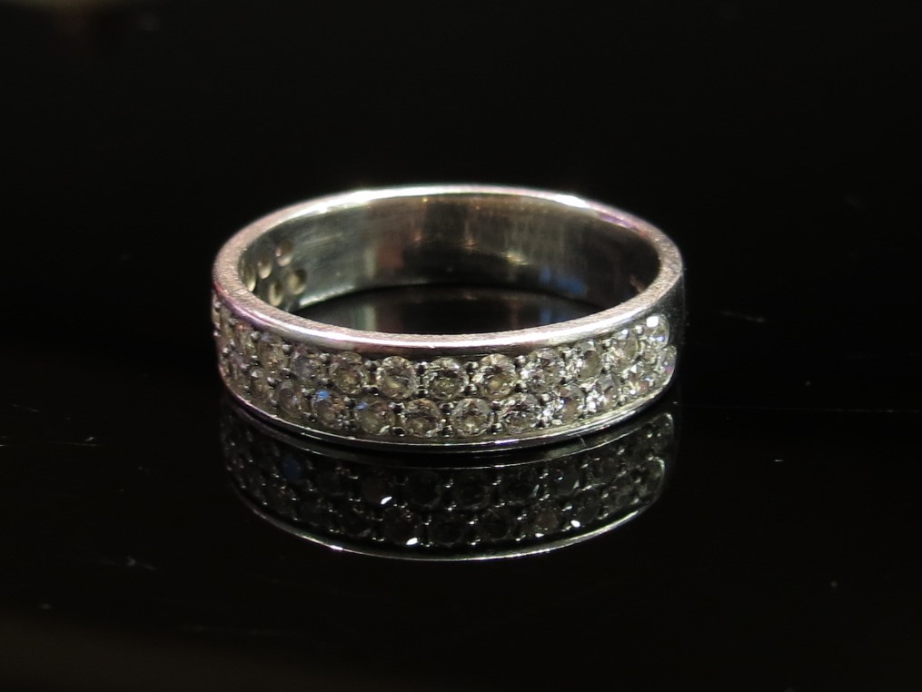 An 18ct white gold diamond double row half hoop ring, size Q, 5.