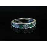 An 18ct white gold emerald and diamond half hoop ring, miss-shaped, size J, 2.