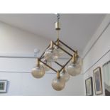 A brass ceiling light with eight crackle glass ball shades