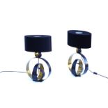 A pair of metal "hoop" table lamps by CTO lighting with black oval shades.