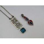 A Mexican silver and enamel brooch, a Swedish pewter and blue glass pendant,