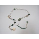 A large silver and turquoise gemstone necklace by Riley Burnett.