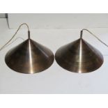 A pair of anodised copper conical form ceiling lights