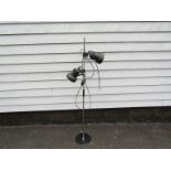 A black and chrome finish standard lamp with twin adjustable spots