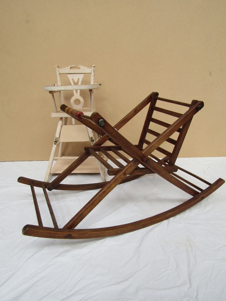 A dolls high chair and a wooden rocking chair
