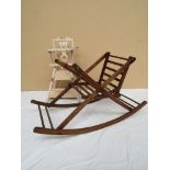 A dolls high chair and a wooden rocking chair