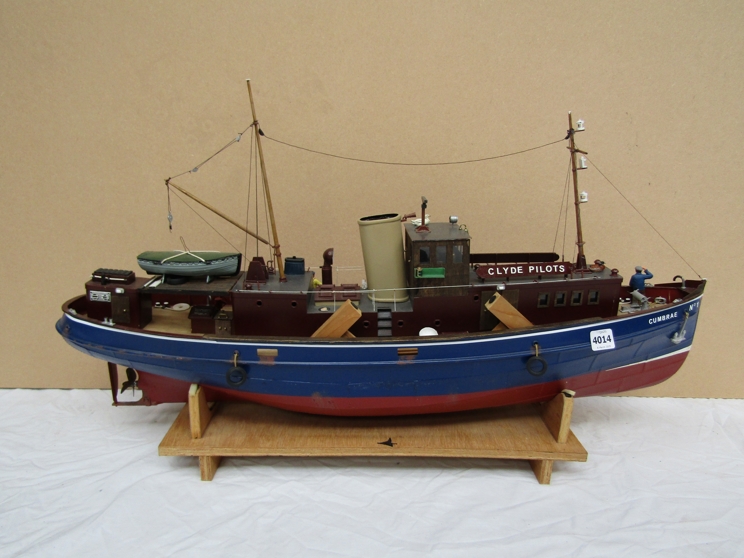 A remote controlled boat with figures on board 'Clyde Pilots' with remote control