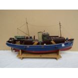 A remote controlled boat with figures on board 'Clyde Pilots' with remote control