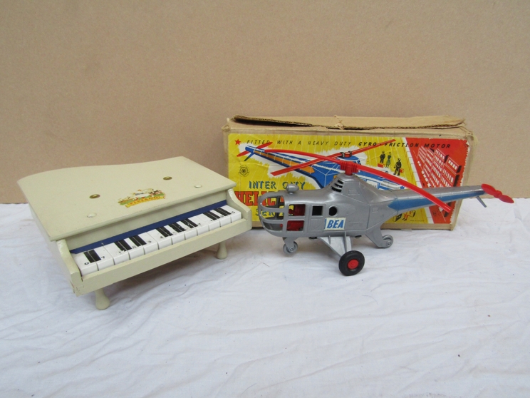 A boxed Tudor Rose Inter City Helicopter Service plastic friction toy and a toy piano