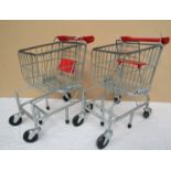 A pair of Melissa & Doug miniature trolleys