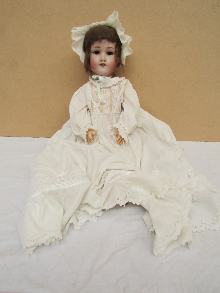 An Armand Marseille bisque headed girl doll on jointed composition body in christening gown 24"