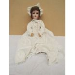 An Armand Marseille bisque headed girl doll on jointed composition body in christening gown 24"