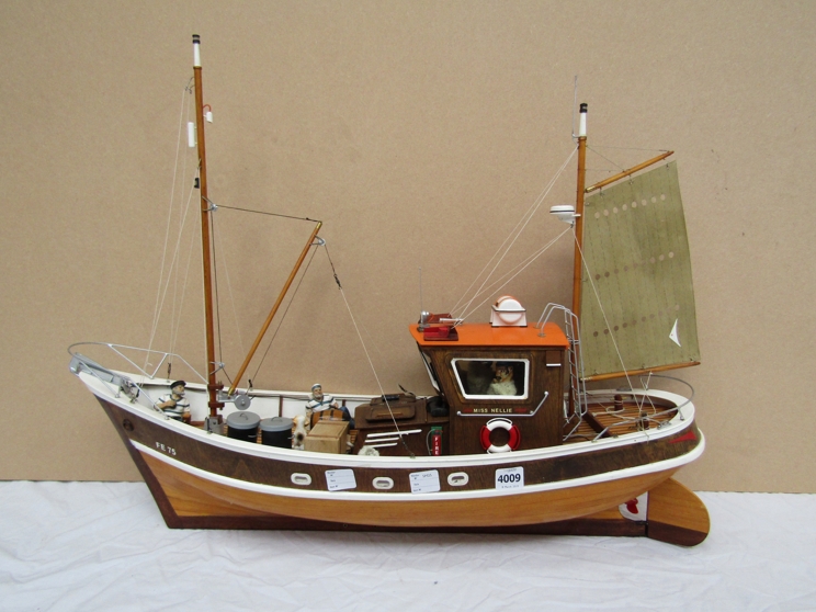 A remote controlled fishing boat, 'Miss Nellie' with figures on board,