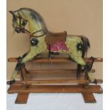 A 19th Century painted wooden rocking horse on trestle rocker, saddle restored,