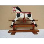 A carved and painted wooden Leeway rocking horse on trestle rocker ,