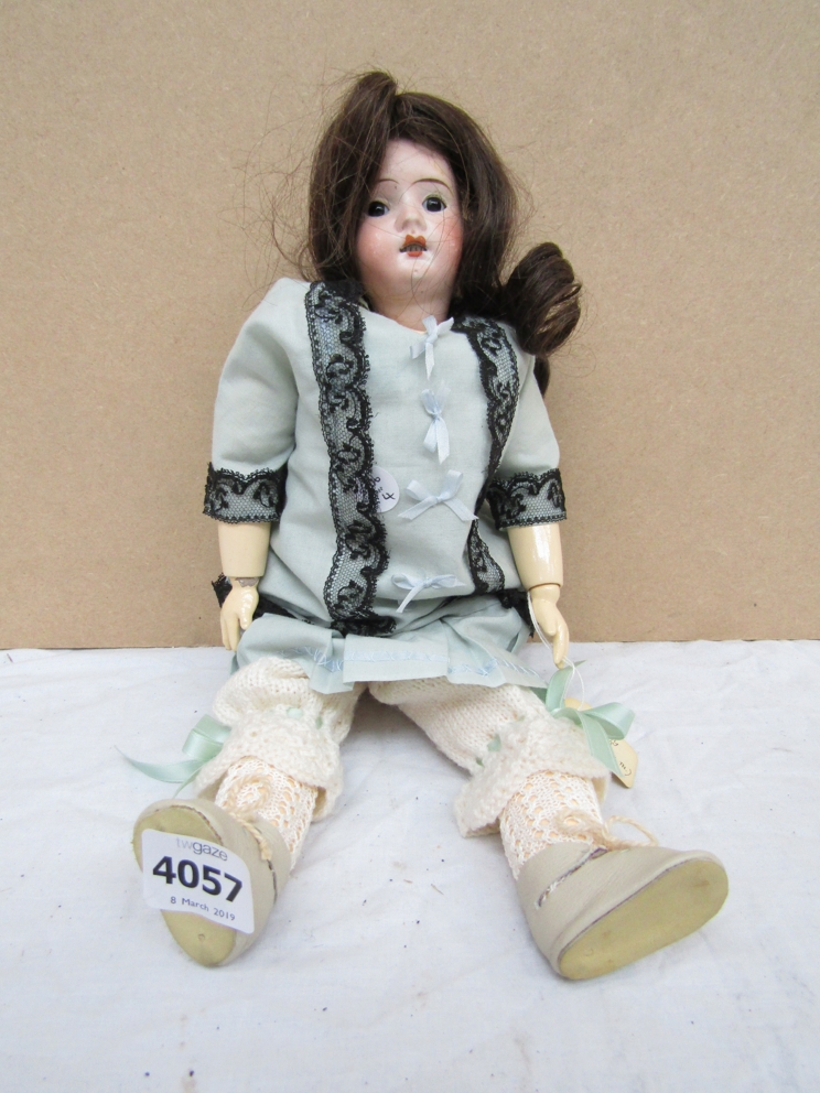 A bisque headed and composition body girl doll, head stamped Germany R9/0Q,