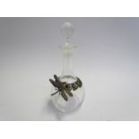 A 19th Century glass perfume bottle with sterling silver dragonfly and foliate design