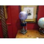 A late Victorian oil lamp circa 1890 the ornate cast base with a Bristol blue ribbed font,