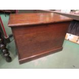 A Circa 1820 oak chest the hinged lid over brass handles on a plinth base with exposed dove tail