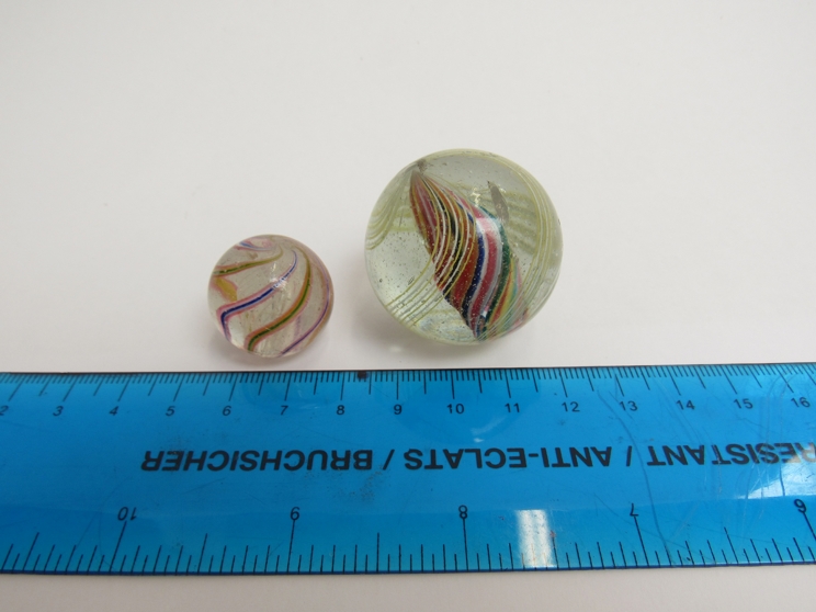 Two Victorian glass marbles with multi coloured spirals