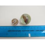 Two Victorian glass marbles with multi coloured spirals