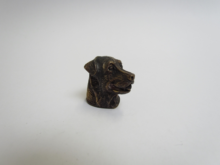 A brass pattenated vesta case in the form of a dogs head,