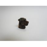 A brass pattenated vesta case in the form of a dogs head,