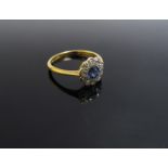 An 18ct gold platinum set sapphire and diamond daisy ring, size M, 2.