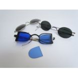 Three cased sets of spectacles including tinted glass